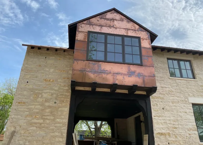 Copper metal panel facade on a stone building for Metal Roof Coating in Highlands
